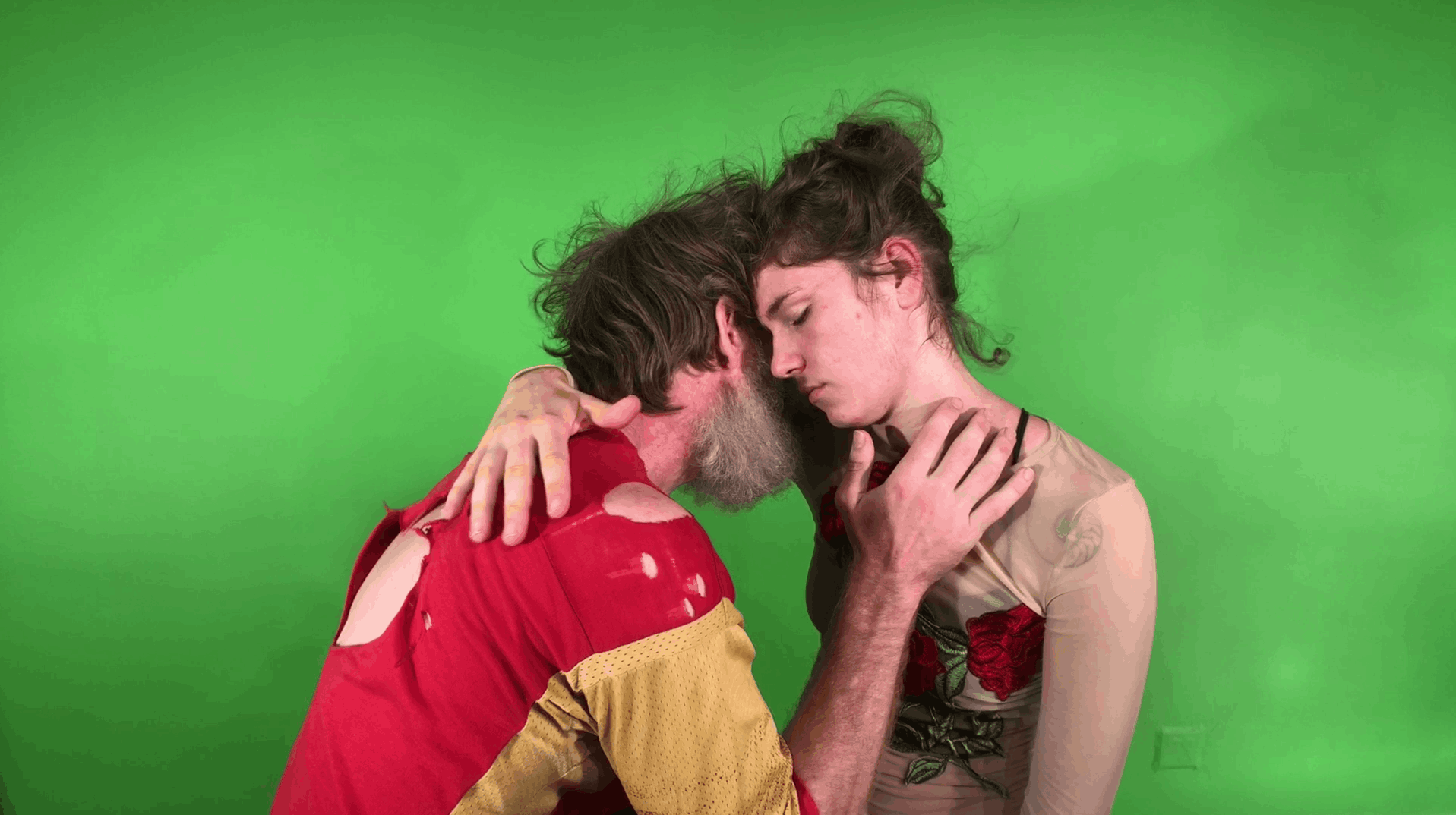 Embrace in front of greenscreen.